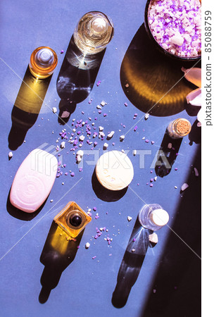 Cosmetic bottles essential oil with contrasting shadows, lotus flower, sea salt. Cosmetic bottles essential oil with contrasting shadows, lotus flower, sea salt. 85088759