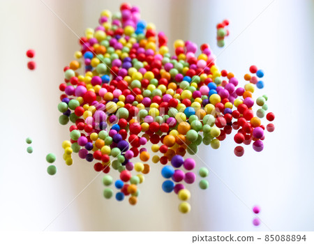 Foam polystyrene round bright colorful beads are reflected on a surface of a glass, mirror. Multicolored pearls floating down, hanging in the air. Foam spherical background. Celebration, fun concept. Foam polystyrene round bright colorful beads are reflected on a surface of a glass, mirror. Multicolored pearls floating down, hanging in the air. Foam spherical background. Celebration, fun concept. 85088894