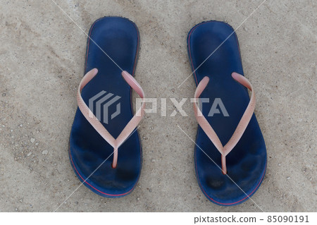 Blue flip-flops left on the concrete floor. Top view of the flip-flops 85090191