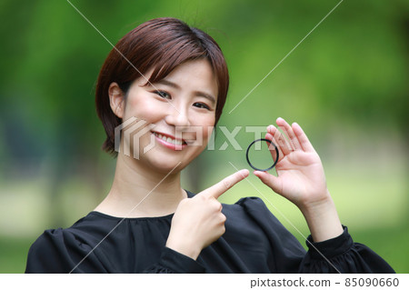 Woman with lens filter 85090660