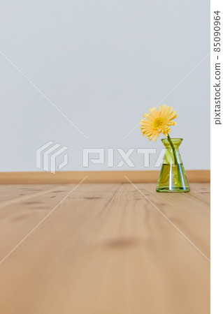 Yellow gerbera flowers in a green vase 85090964