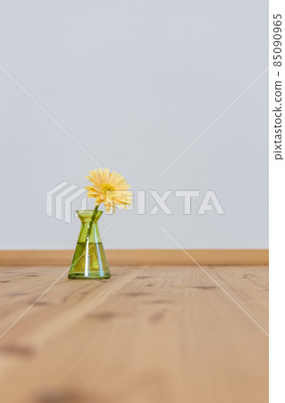 Yellow gerbera flowers in a green vase 85090965