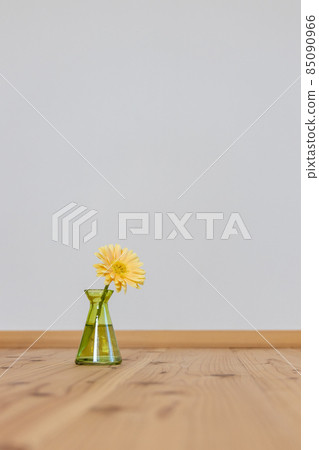 Yellow gerbera flowers in a green vase 85090966