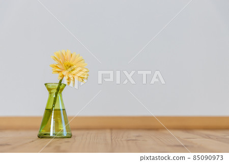 Yellow gerbera flowers in a green vase Yellow gerbera flowers in a green vase 85090973
