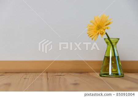 Yellow gerbera flower in a green flower vase Yellow gerbera flower in a green flower vase 85091004