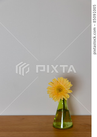 Yellow gerbera flower in a green flower vase Yellow gerbera flower in a green flower vase 85091005