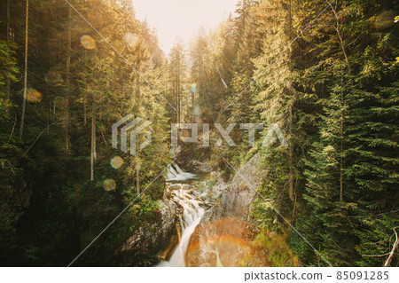 Tatra National Park, Poland. Waterfall Wodogrzmoty Mickiewicza In Summer Mountains Sunset Landscape. Sunlight Through Trees In Tatras. European Nature. UNESCO Tatra National Park, Poland. Waterfall Wodogrzmoty Mickiewicza In Summer Mountains Sunset Landscape. Sunlight Through Trees In Tatras. European Nature. UNESCO 85091285