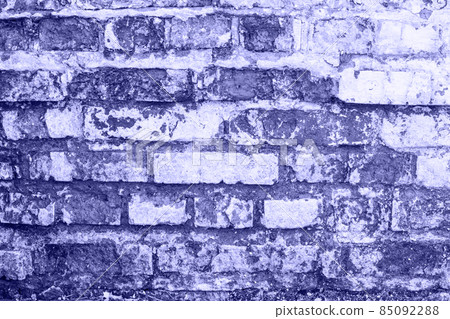 empty old brick wall texture. Shabby building facade with damaged plaster in very peri trendy color of the year 2022. empty old brick wall texture. Shabby building facade with damaged plaster in very peri trendy color of the year 2022. 85092288