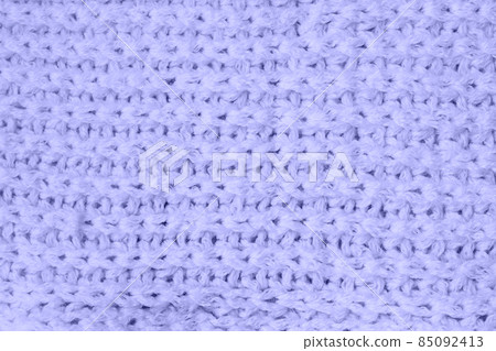 Sweater or scarf Pattern Of Knitted Fabric Texture Background in very peri trendy color of the year 2022. Sweater or scarf Pattern Of Knitted Fabric Texture Background in very peri trendy color of the year 2022. 85092413