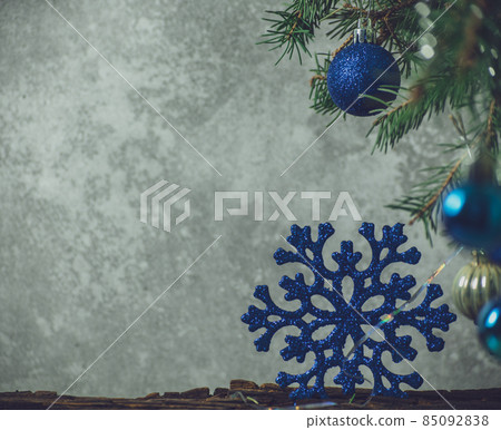 Spruce branches decorated with blue Christmas toys Spruce branches decorated with blue Christmas toys 85092838