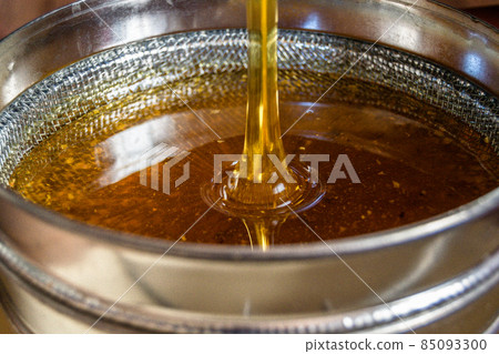 Drop of bee honey drip from hexagonal honeycombs 85093300