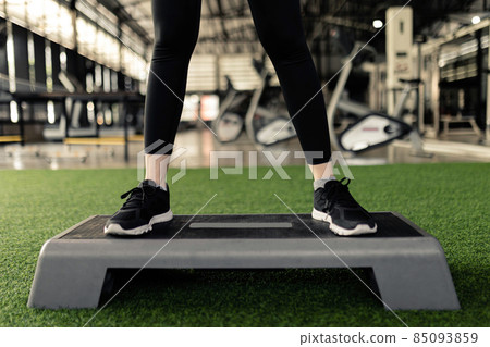 exercise concept The female exercise person doing squats by standing with feet a little wider than hip width, toes facing front on the grey platform 85093859