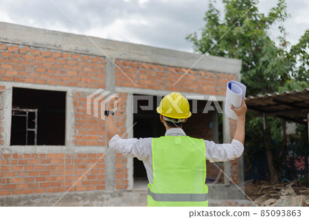 engineer concept The constructing guy looking at the construction site and raising his hands for expressing his rejoice moment 85093863
