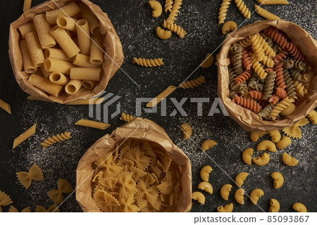 pasta concept three types of pasta put into paper bags on the black background pasta concept three types of pasta put into paper bags on the black background 85093867