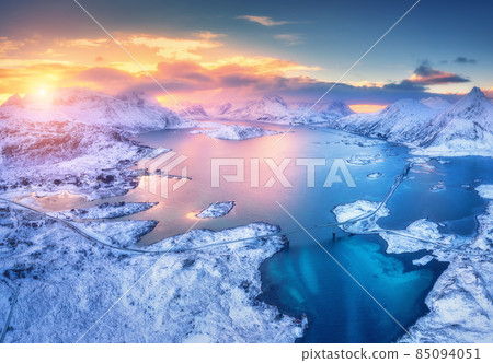Aerial view of sea, snowy islands, mountains, road, blue sky 85094051