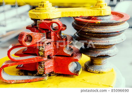 This is machine for bending reinforcement or pipes. Close-up of equipment in production hall This is machine for bending reinforcement or pipes. Close-up of equipment in production hall 85096690
