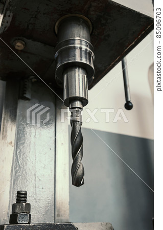 Close-up machine for drilling holes in metal. Equipment with drill for vertical drilling. Factory 85096703