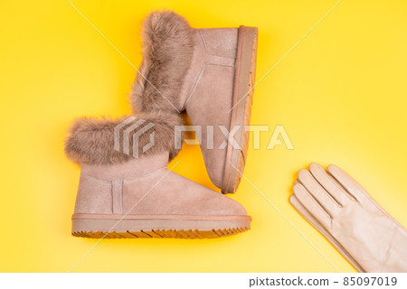 shopping concept. female leather stylish footwear. pair of fashionable leather ugg boots. 85097019