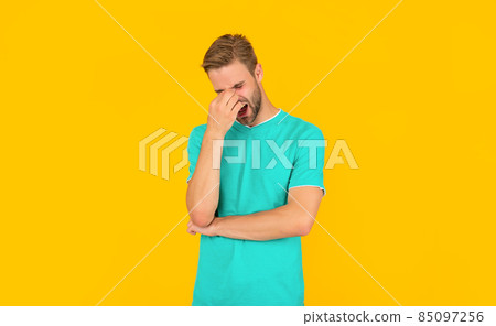 shouting young man has headache on yellow background. hair and beard care shouting young man has headache on yellow background. hair and beard care 85097256