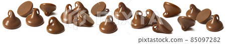 Milk chocolate drops or chips set isolated on white background. Sweet details. 85097282