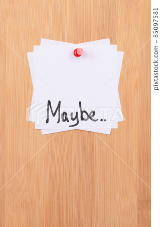 MAYBE.. - White Sticky Notes with Written Word MAYBE, Pinned to the Wooden Message Board 85097581