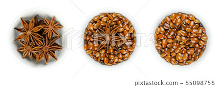 Star anise fruits and seeds in white bowls. Known as staranise, star aniseed or badian. Dried, star-shaped pericarp and seeds of Illicium verum, containing anethole, a spice with intense anise flavor. Star anise fruits and seeds in white bowls. Known as staranise, star aniseed or badian. Dried, star-shaped pericarp and seeds of Illicium verum, containing anethole, a spice with intense anise flavor. 85098758