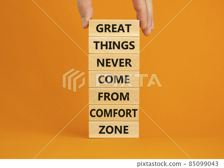 Out from comfort zone symbol. Wooden blocks with words Great things never come from comfort zone. Beautiful orange background, copy space. Businessman hand. Business, out from comfort zone concept. 85099043