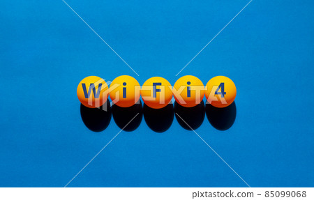 WiFi 4 symbol. The concept word WiFi 4 on orange table tennis balls. Beautiful blue table, blue background, copy space. Business, technology and WiFi 4 or WiFi4 concept. WiFi 4 symbol. The concept word WiFi 4 on orange table tennis balls. Beautiful blue table, blue background, copy space. Business, technology and WiFi 4 or WiFi4 concept. 85099068