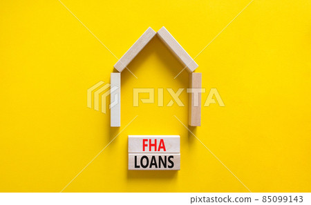 FHA federal housing administration loans symbol. Concept words 'FHA federal housing administration loans' on wooden blocks on a beautiful yellow background. Business and FHA loans concept. Copy space. FHA federal housing administration loans symbol. Concept words 'FHA federal housing administration loans' on wooden blocks on a beautiful yellow background. Business and FHA loans concept. Copy space. 85099143