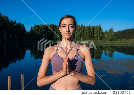 Calm young woman taking deep breath of fresh air relaxing meditating enjoying peace, serene tranquil girl doing yoga exercise feel no stress free relief 85100791