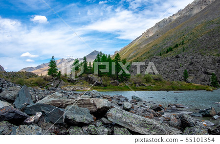 Mountain lake on the background of snow-capped peaks in the Altai Republic. Mountain lake on the background of snow-capped peaks in the Altai Republic. 85101354