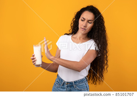 Lactose Intolerance. Young Woman Refusing Drink Milk At Studio 85101707