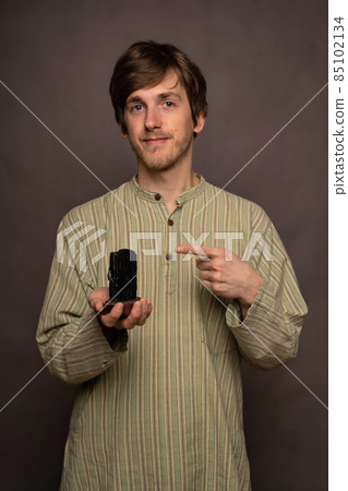 Man holding crystal on grey background 85102134