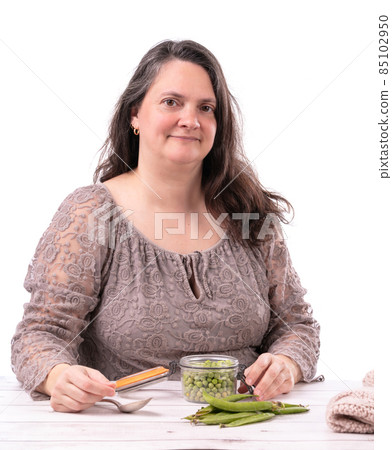 Woman with a jar of raw peas Woman with a jar of raw peas 85102950