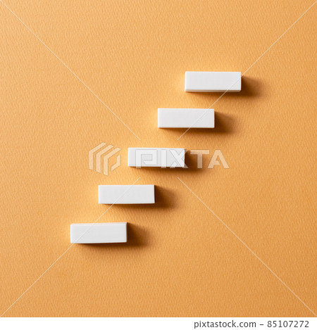 Stairs block on orange background. Growth and challenge concept 85107272