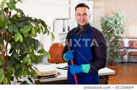 Young man cleaner working at office Young man cleaner working at office 85108664