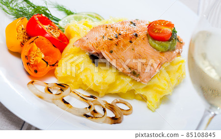 Tasty fried trout fillet with mashed potatoes, peppers, onion and greens Tasty fried trout fillet with mashed potatoes, peppers, onion and greens 85108845