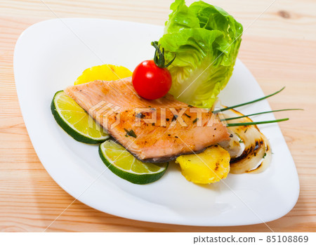 Baked trout fillet with potatoes on white plate 85108869