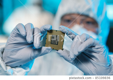 Gloved hands of contemporary scientist holding microchip Gloved hands of contemporary scientist holding microchip 85109836