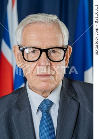 Serious senior politician in eyeglasses and suit 85110011