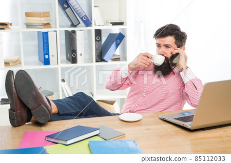Business person talk on mobile phone drinking cup of tea Business person talk on mobile phone drinking cup of tea 85112033