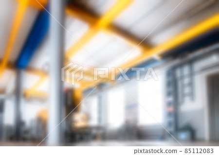 Empty production room in factory. Unfocused backdrop is industrial theme. Blurry background. Place 85112083