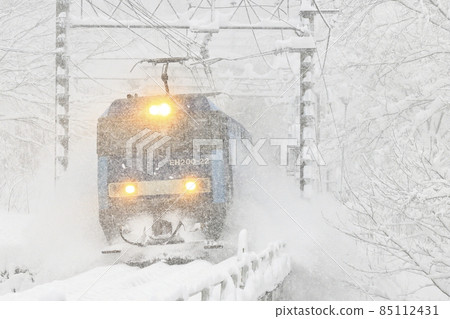 A freight train running on the Joetsu line in a blizzard 85112431