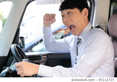 Image of a businessman driving dangerously Image of a businessman driving dangerously 85112725