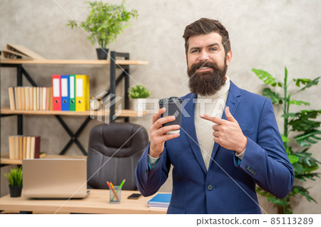smiling brutal ceo in suit has lunch break point finger on takeaway coffee cup, coffee break. smiling brutal ceo in suit has lunch break point finger on takeaway coffee cup, coffee break. 85113289