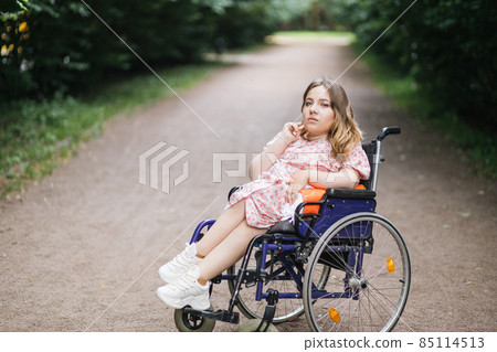 Caucasian woman with disability posing at summer park Caucasian woman with disability posing at summer park 85114513