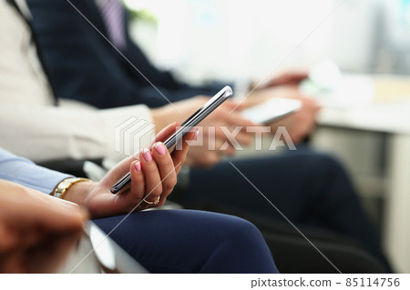 Female hands with manicure hold mobile phone device Female hands with manicure hold mobile phone device 85114756
