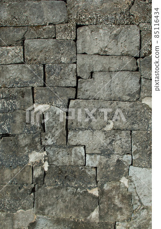 Gray stone walls cut out and piled up intricately Gray stone walls cut out and piled up intricately 85116434