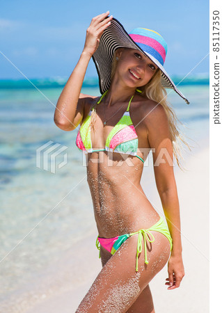 Slender lovely blonde posing on a tropical beach in the Dominican Republic. A girl in a bikini. Slender lovely blonde posing on a tropical beach in the Dominican Republic. A girl in a bikini. 85117350
