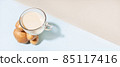 Alternative plant milk. Modern composition with a cup with potato milk that balances on a pile of potatoes 85117416